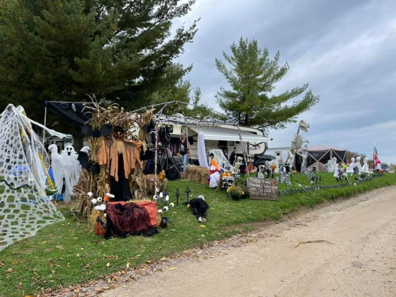 People gathered at a decorated RV campsite